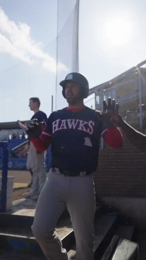 Jonkers high fives in the dugout