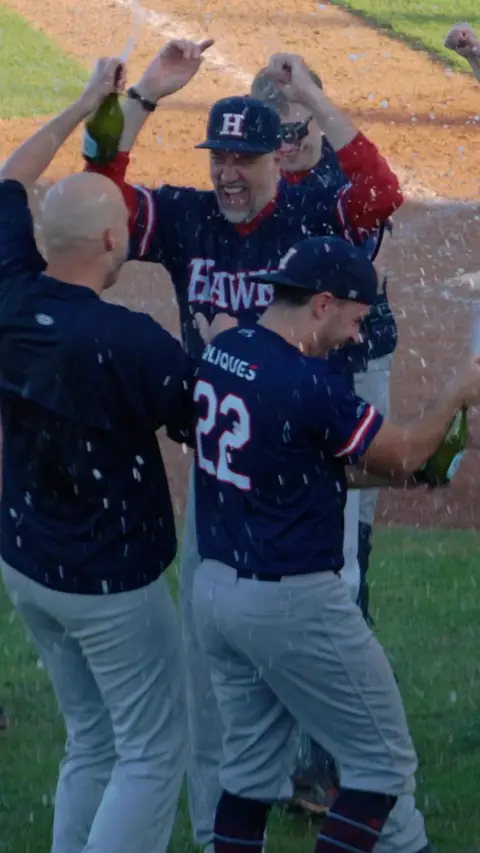 Team celebrates the win with coach