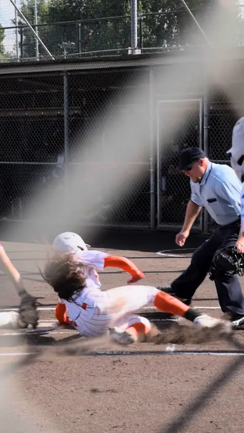Jazmyn Jackson sliding home and celebrating