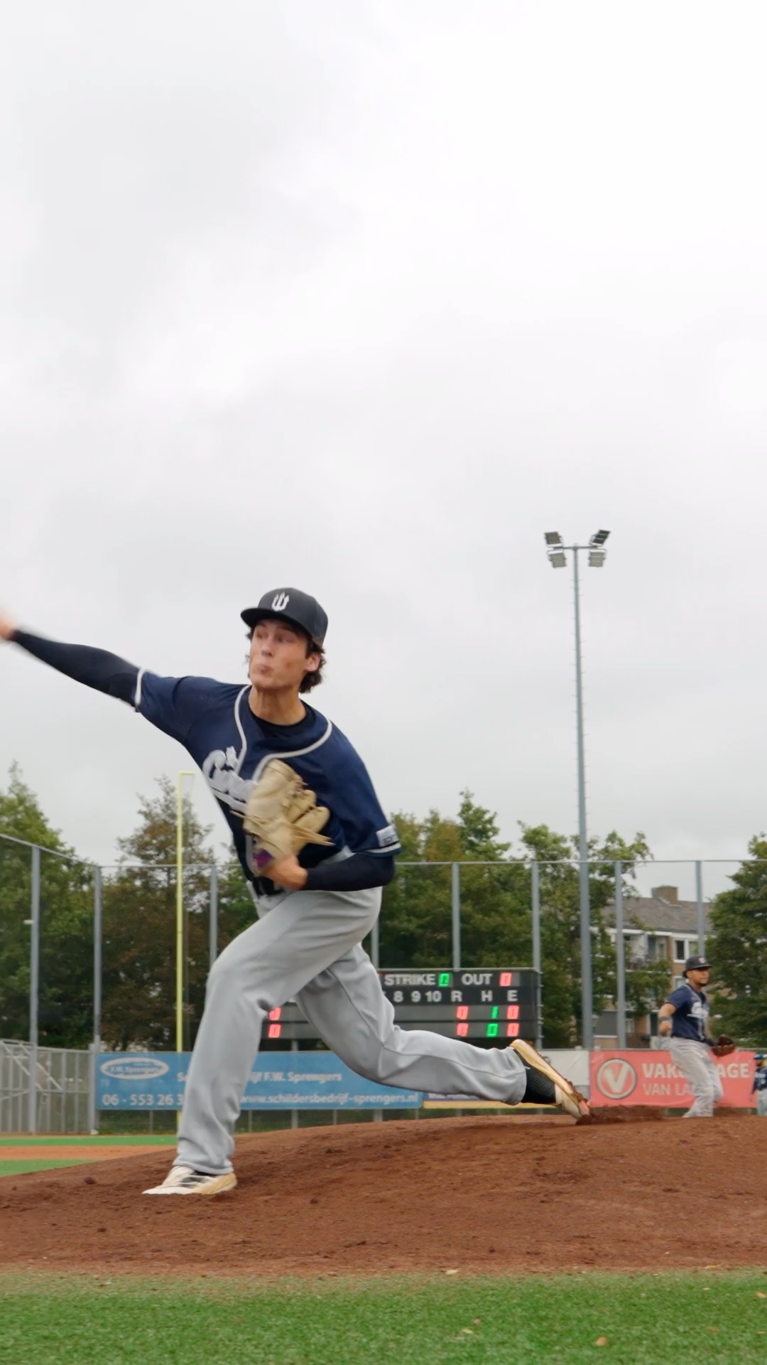 Rosario Campisano walks to the mound and throws his warm up pitches