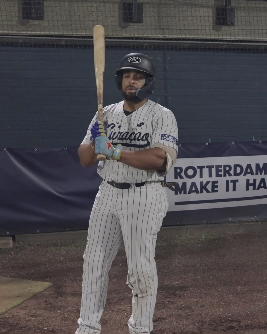 Dre Celestijn walks past the stadium logo to the plate v4.5
