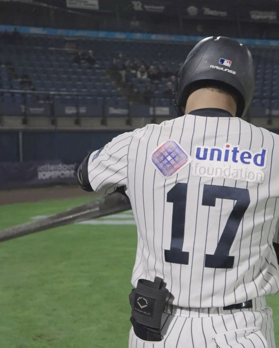 Jowell Sprock walks past the stadium logo to the plate v4.5